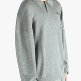 Grey knitwear worn by a person, showing the knitwear's fit