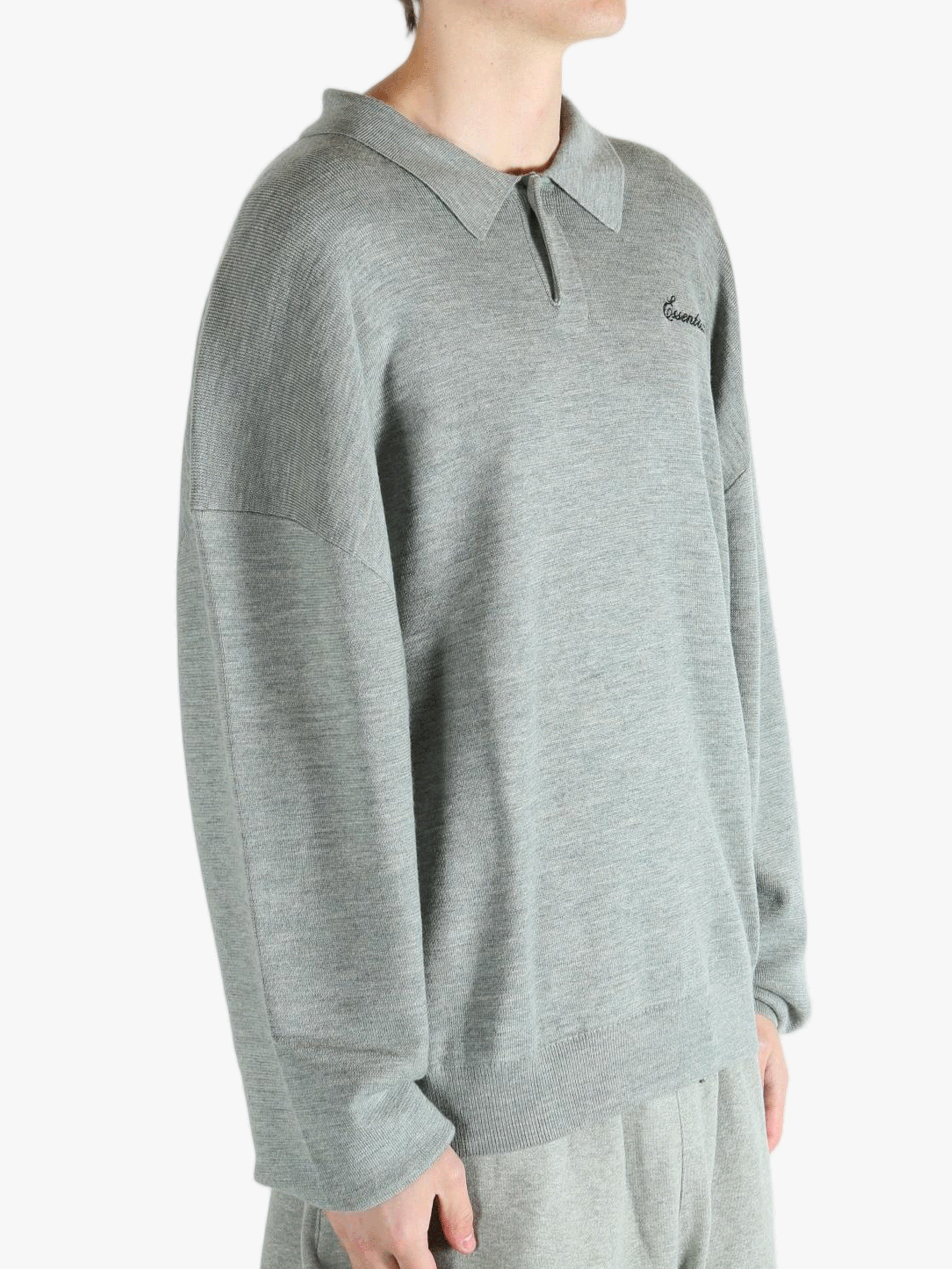 Grey knitwear worn by a person, showing the knitwear's fit