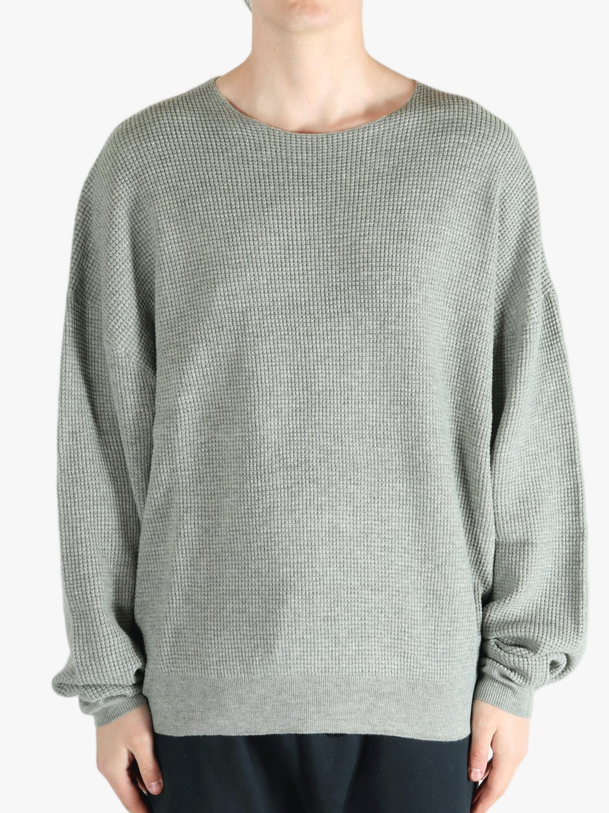 Grey sweater worn by a person, showing the sweater fit