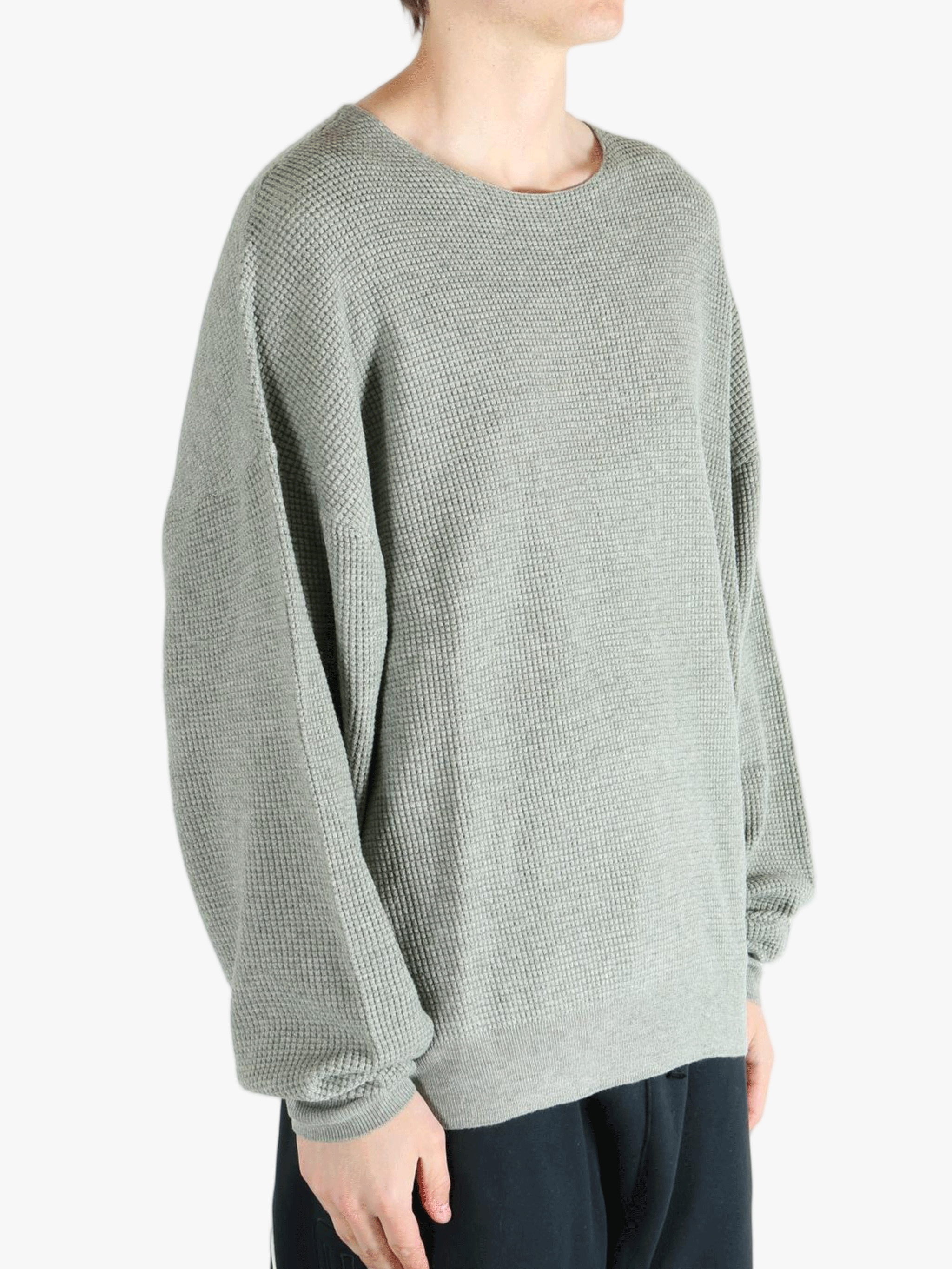 Grey sweater worn by a person, showing the sweater fit