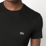 Close up of the black t-shirt, showing texture of the cotton fabric
