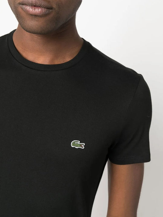 Close up of the black t-shirt, showing texture of the cotton fabric