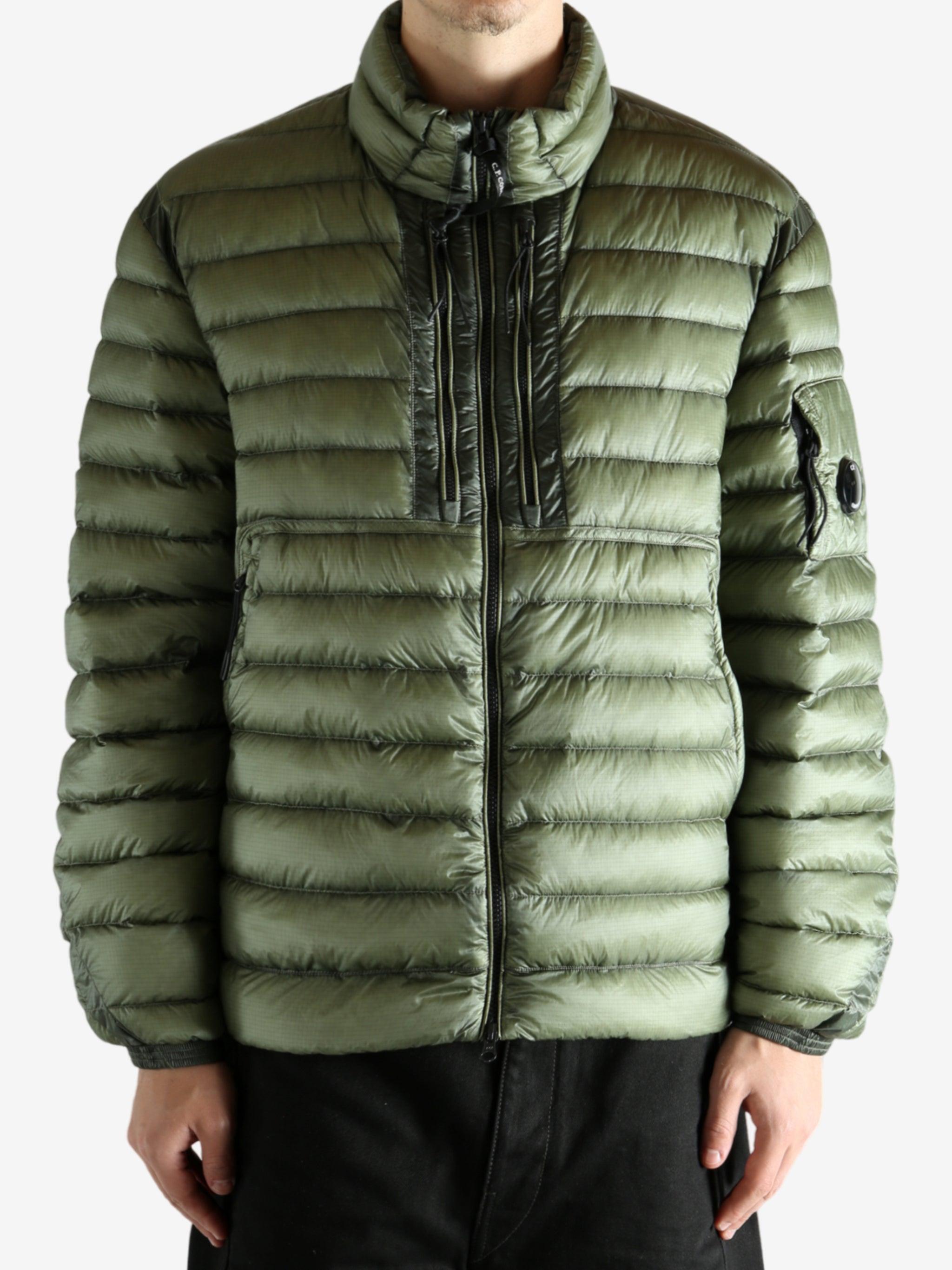 Green jacket worn by a person, showing the jacket's fit