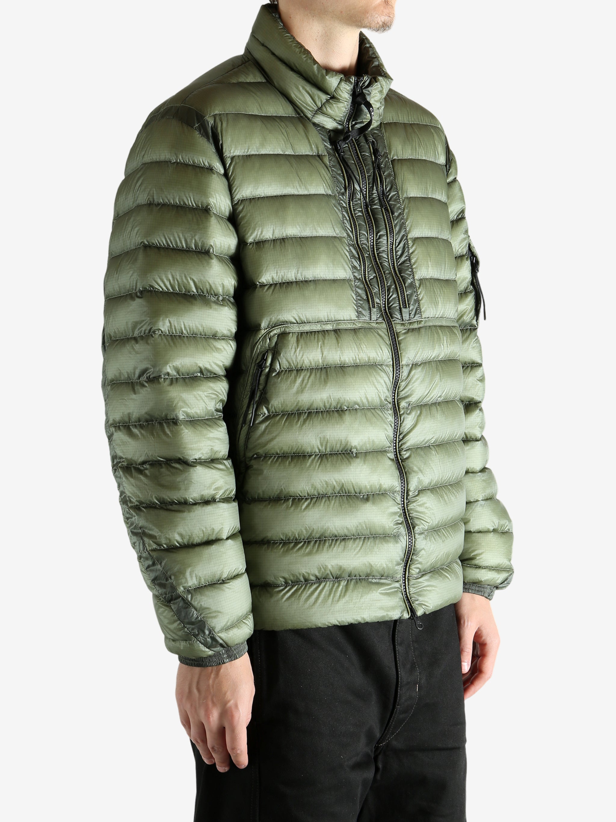 Green jacket worn by a person, showing the jacket's fit