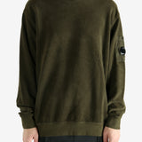 Green sweatshirt worn by a person, showing the sweatshirt's fit