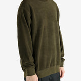Green sweatshirt worn by a person, showing the sweatshirt's fit