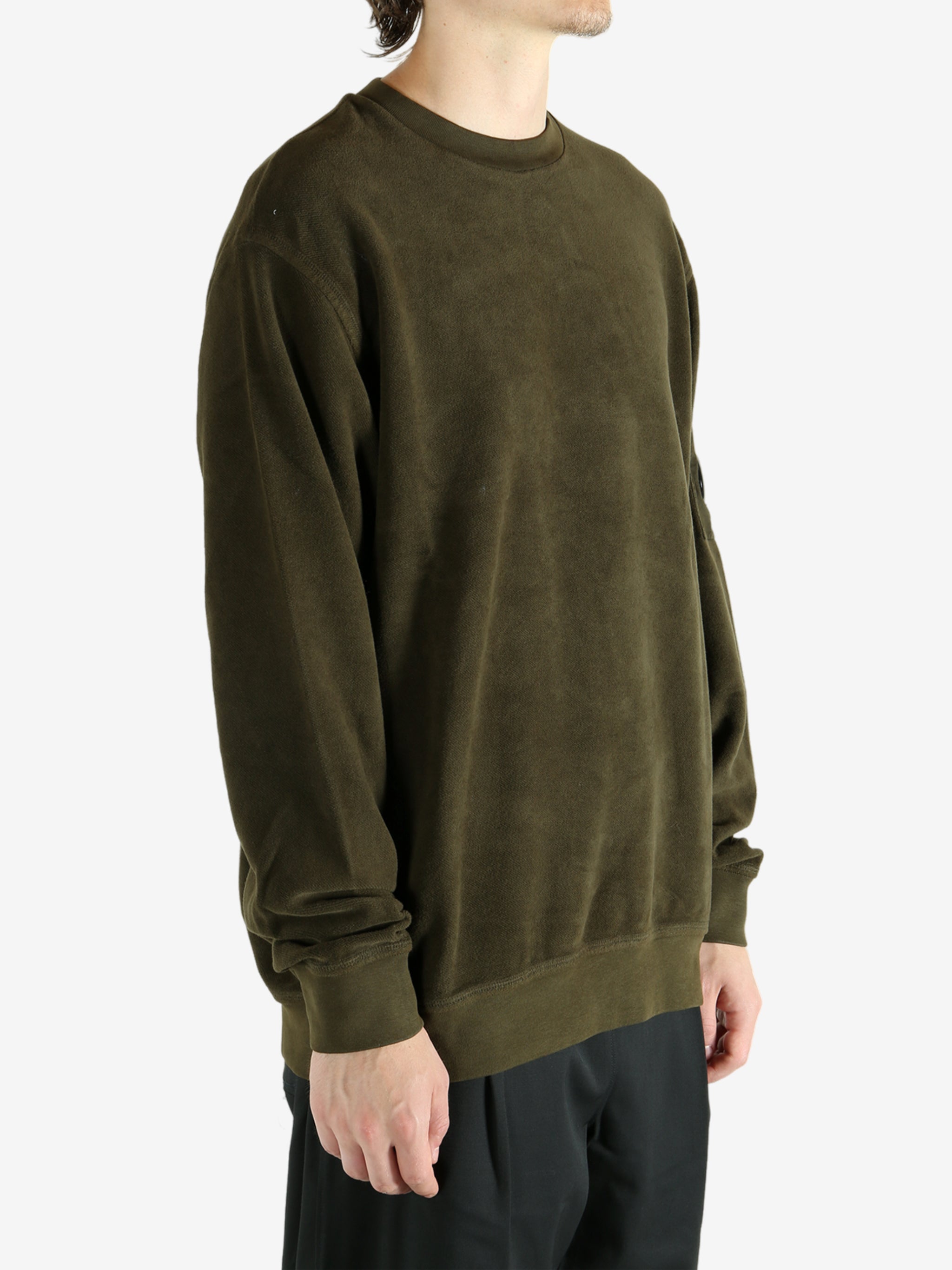 Green sweatshirt worn by a person, showing the sweatshirt's fit