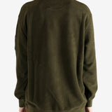 Green sweatshirt worn by a person, showing the sweatshirt's fit