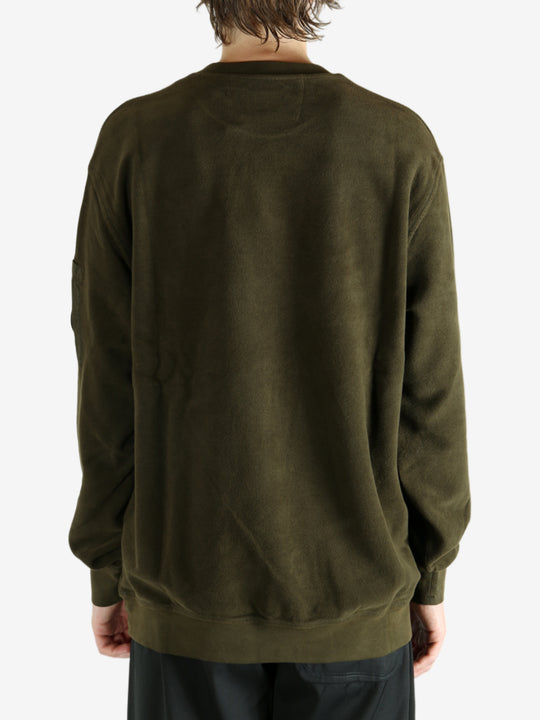 Green sweatshirt worn by a person, showing the sweatshirt's fit