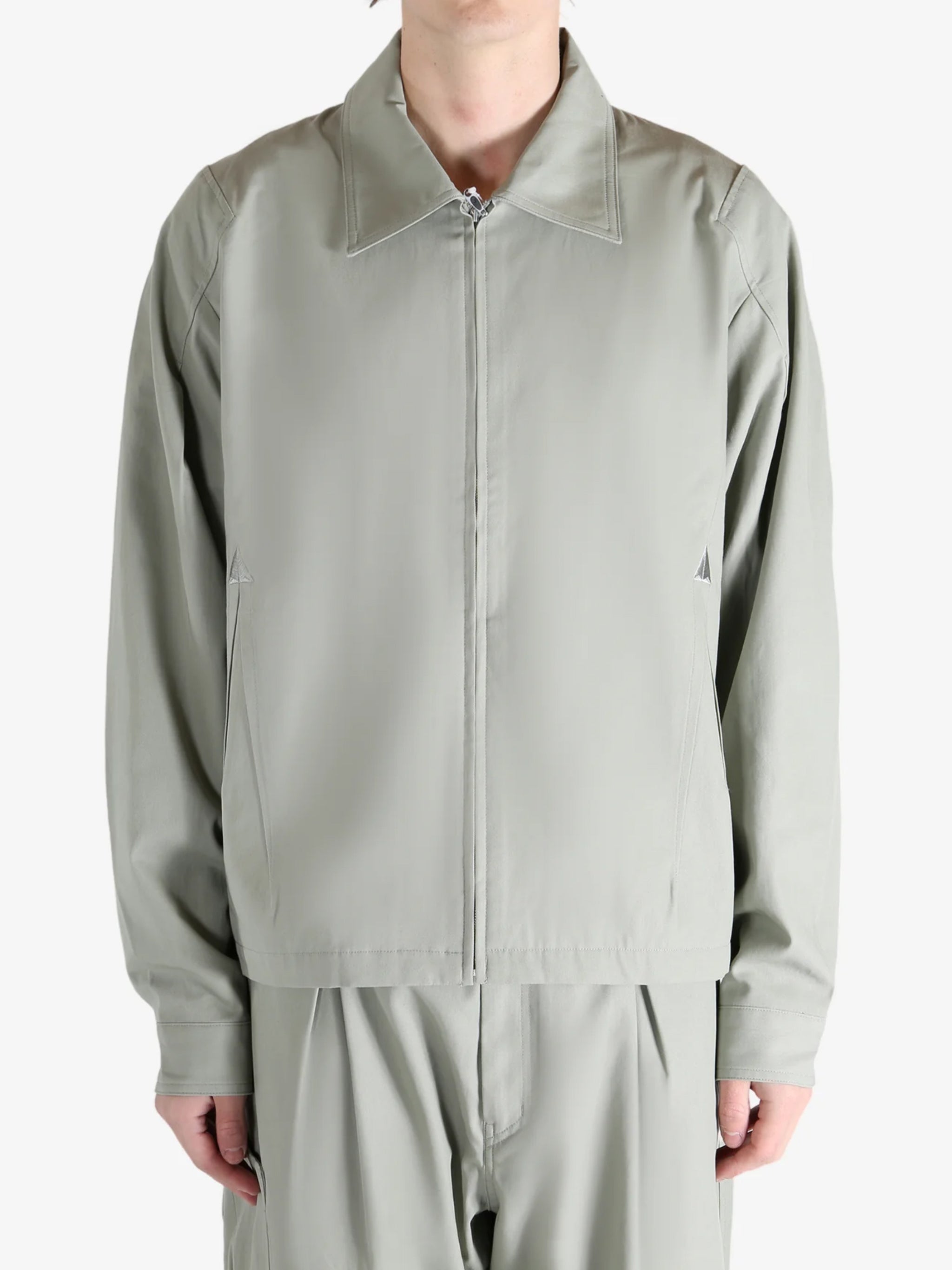 Grey jacket worn by a person, showing the jacket's fit