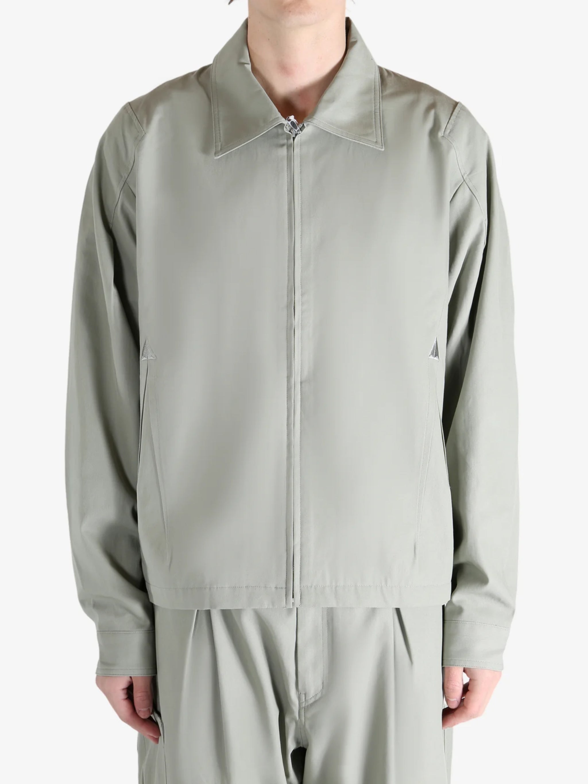 Grey jacket worn by a person, showing the jacket's fit