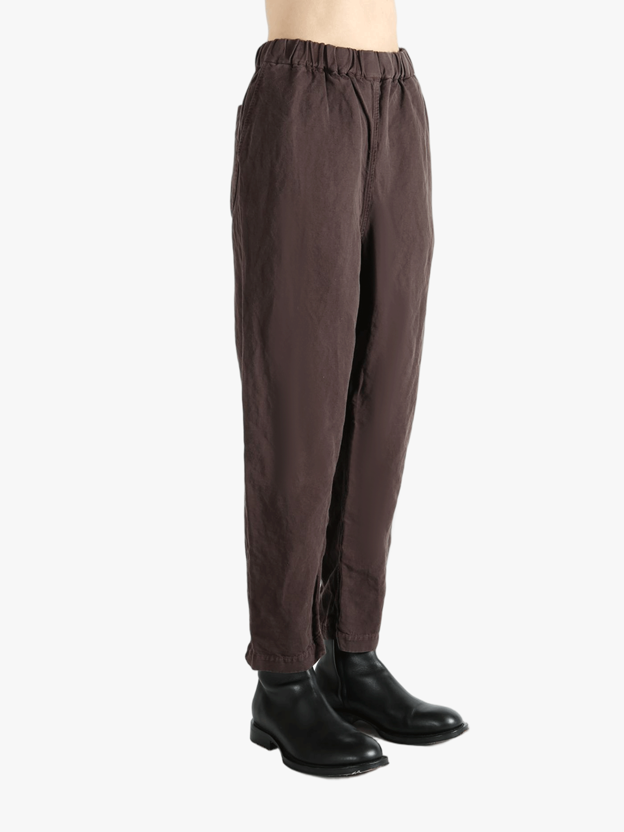 Brown pants worn by a person,showing the pants fit