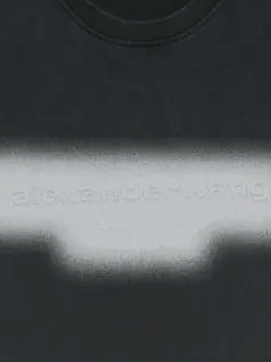 Close-up of black t-shirt, showing the detial of the logo