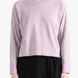 Purple top worn by a person, showing the top's fit