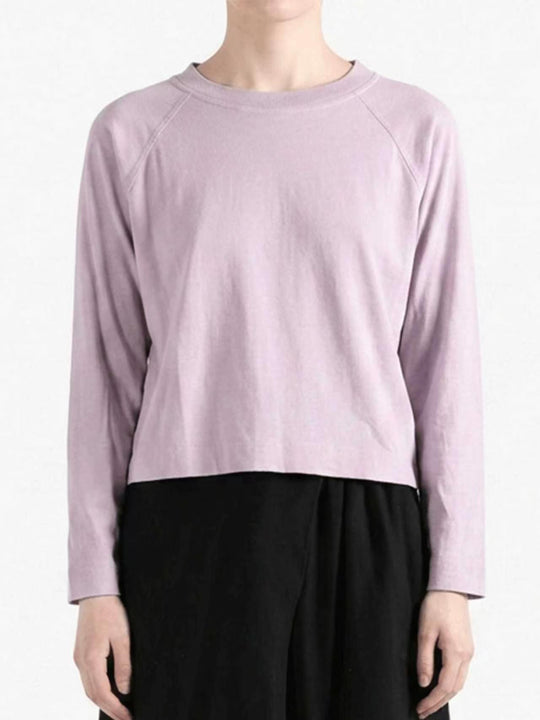 Purple top worn by a person, showing the top's fit