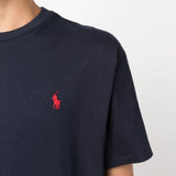 Close up of navy t-shirt, showing texture of the cotton fabric.
