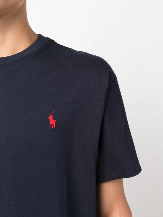 Close up of navy t-shirt, showing texture of the cotton fabric.