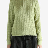 Green knitwear worn by a person, showing the knitwear's fit