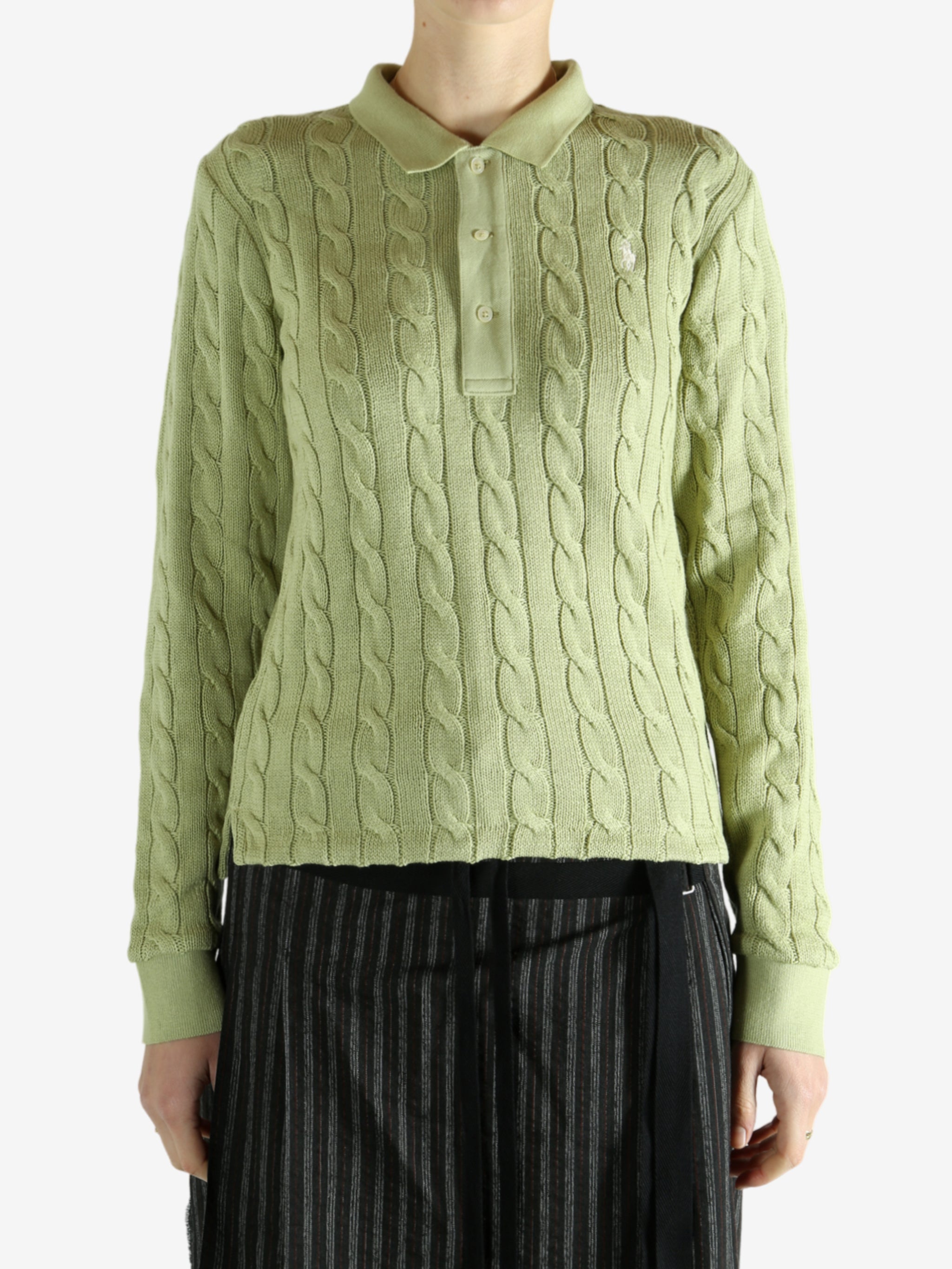 Green knitwear worn by a person, showing the knitwear's fit