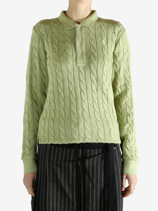 Green knitwear worn by a person, showing the knitwear's fit