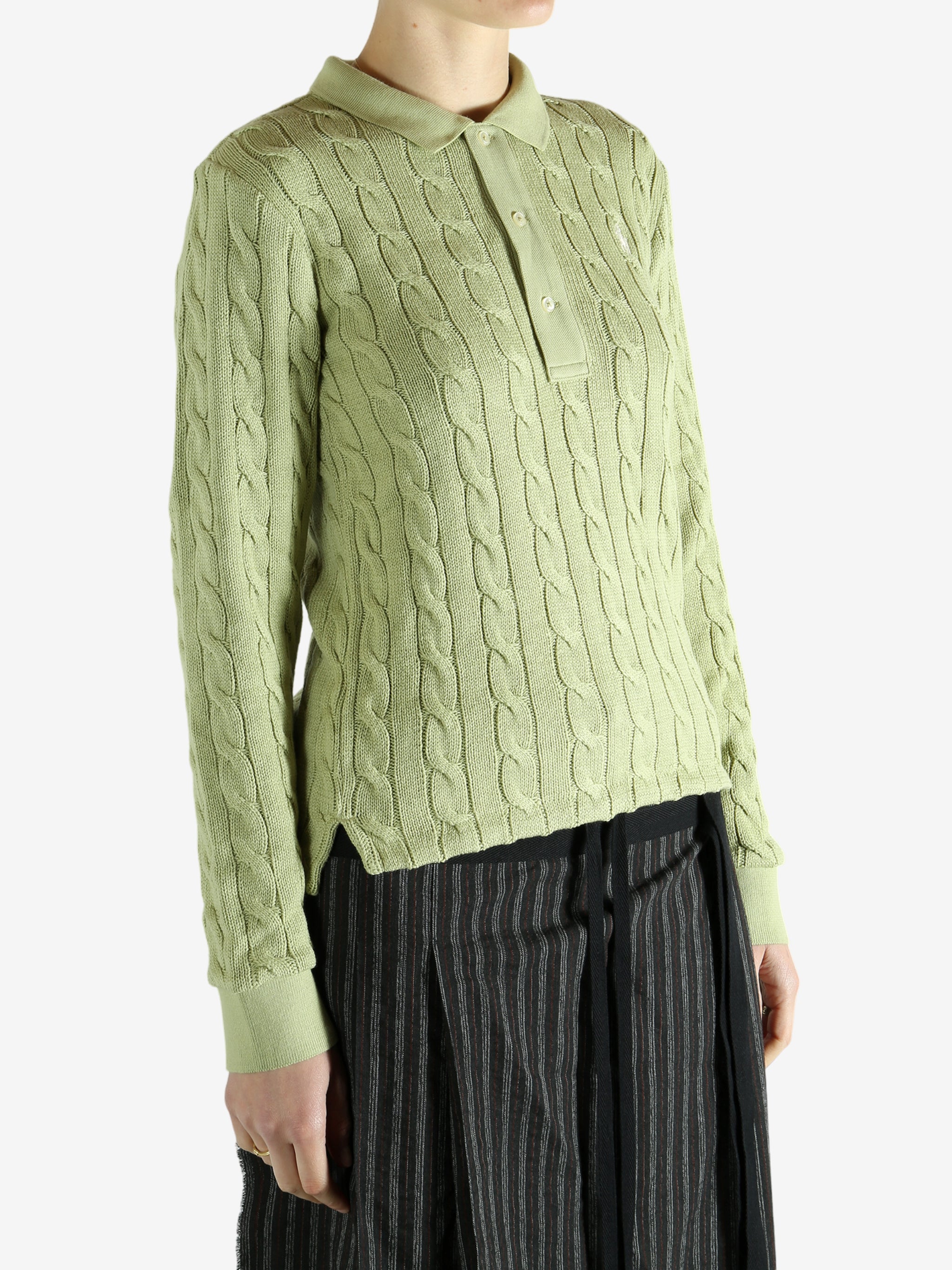 Green knitwear worn by a person, showing the knitwear's fit