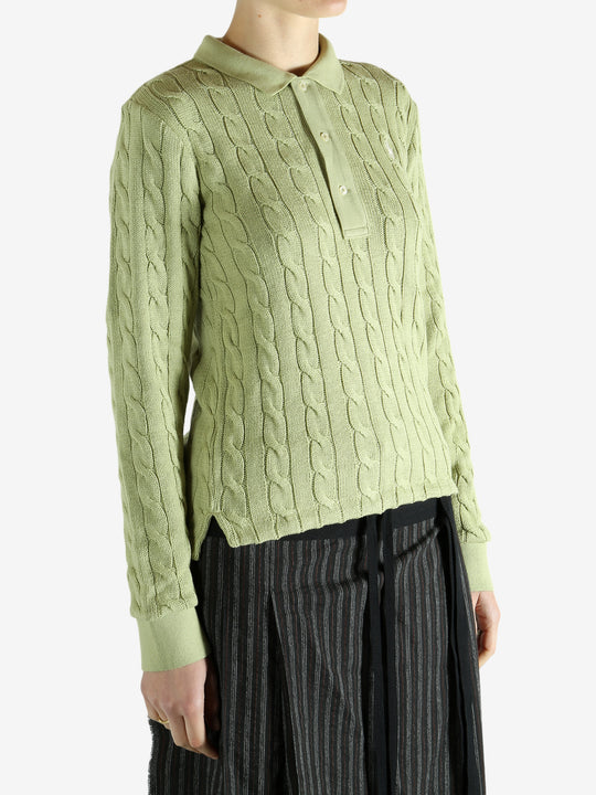 Green knitwear worn by a person, showing the knitwear's fit