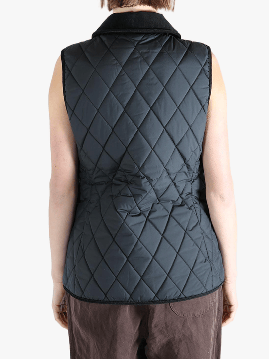 Black coat worn by a person, showing the coat's fit