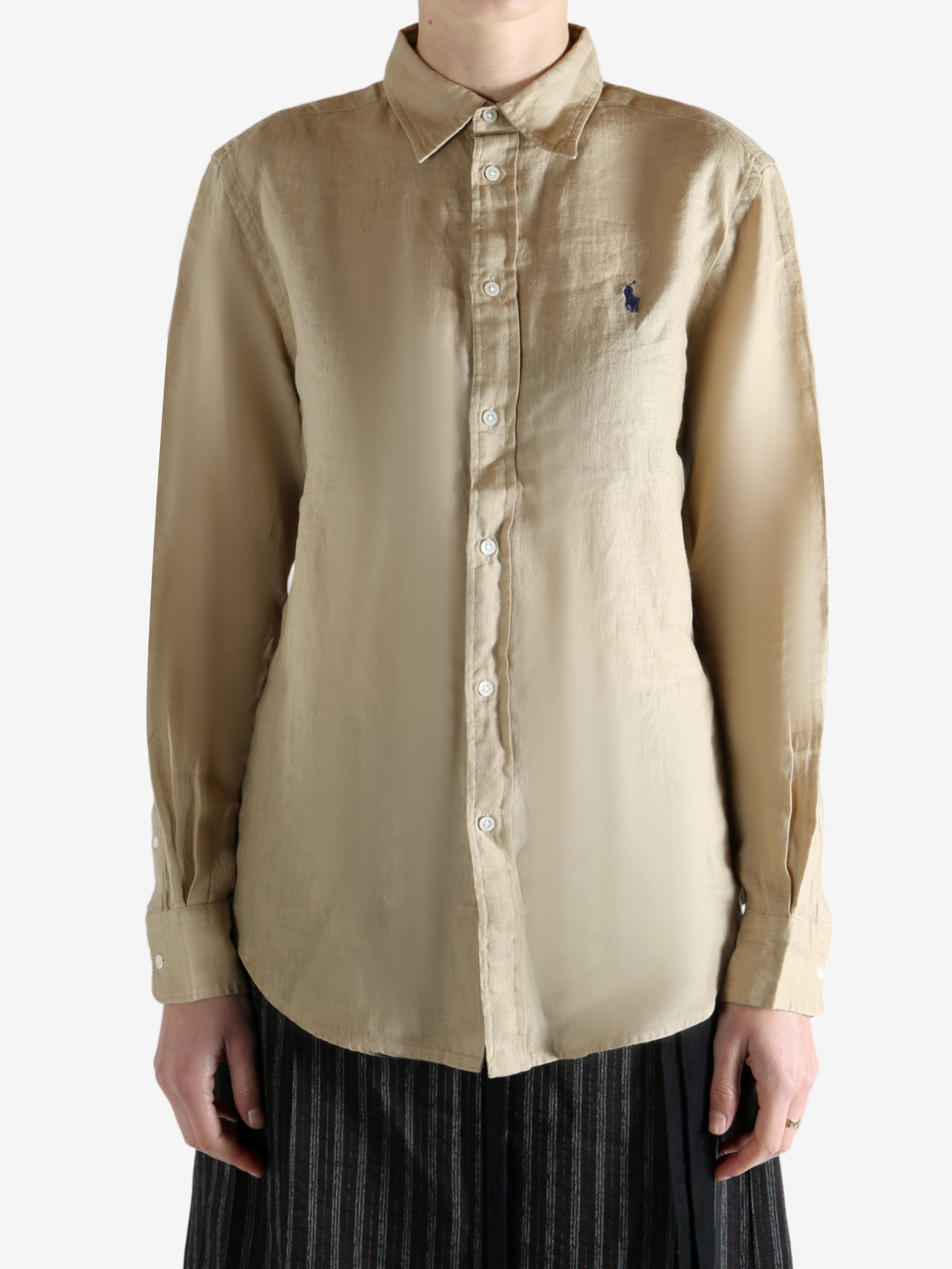 Beige shirt worn by a person, showing the shirt fit