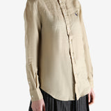 Beige shirt worn by a person, showing the shirt fit