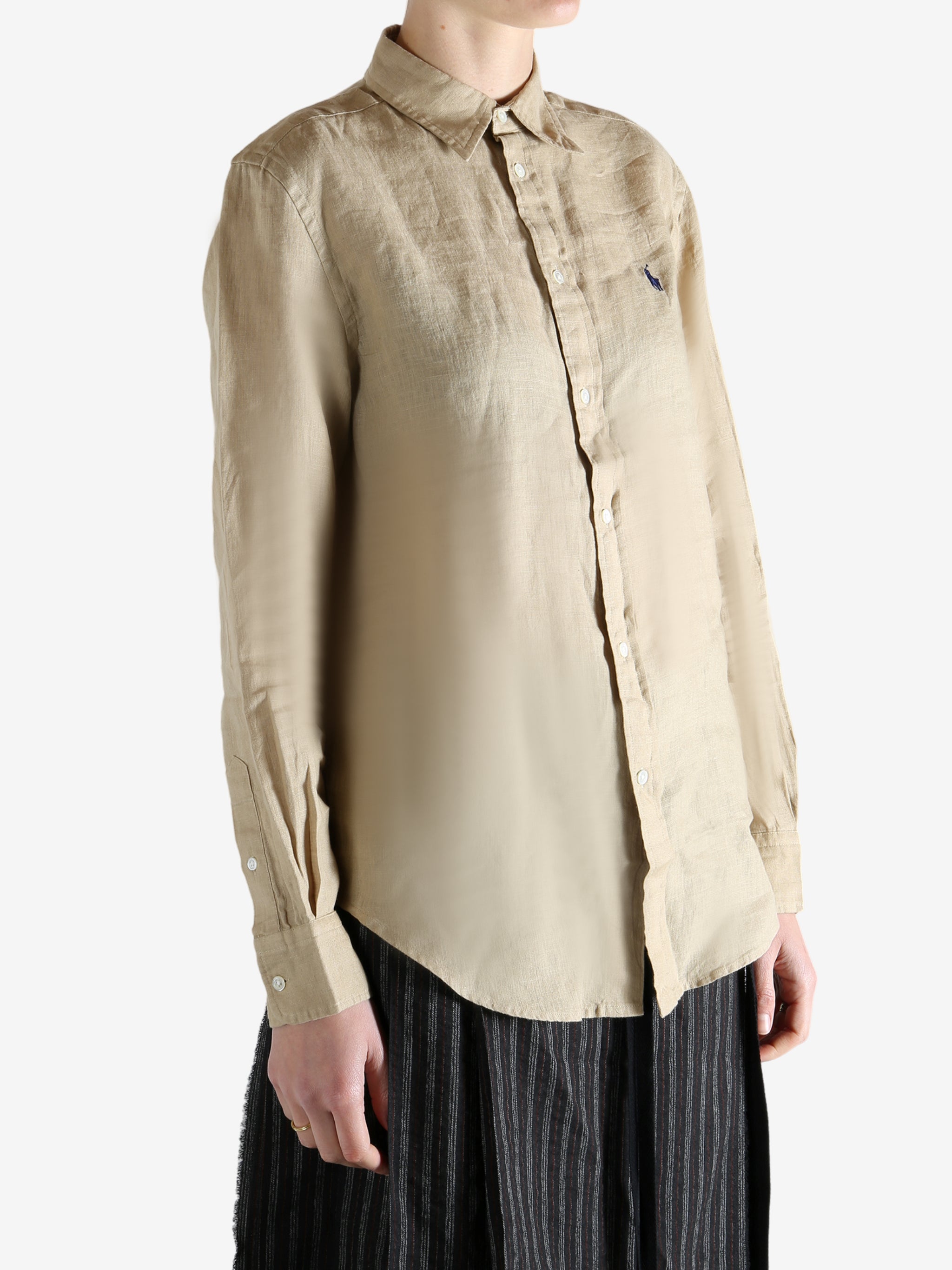 Beige shirt worn by a person, showing the shirt fit