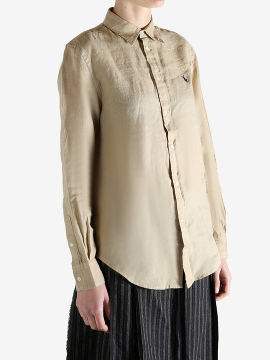 Beige shirt worn by a person, showing the shirt fit