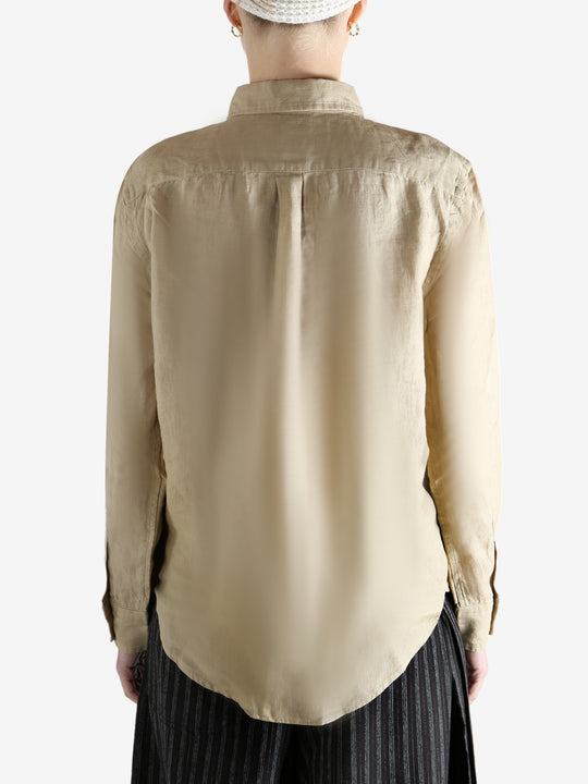 Beige shirt worn by a person, showing the shirt fit