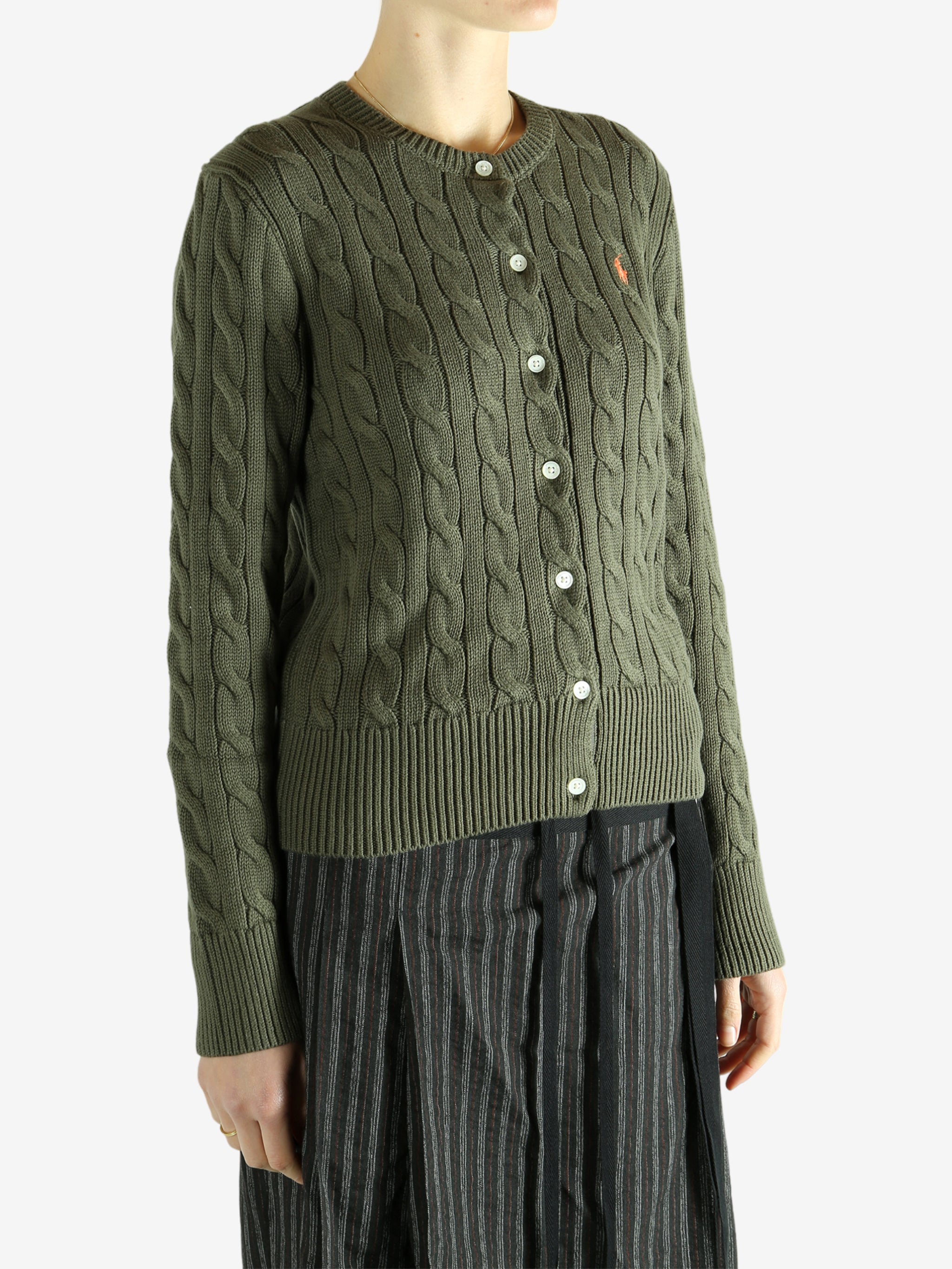 Green cardigan worn by a person, showing the cardigan's fit