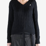 Black knitwear worn by a person, showing the knitwear fit