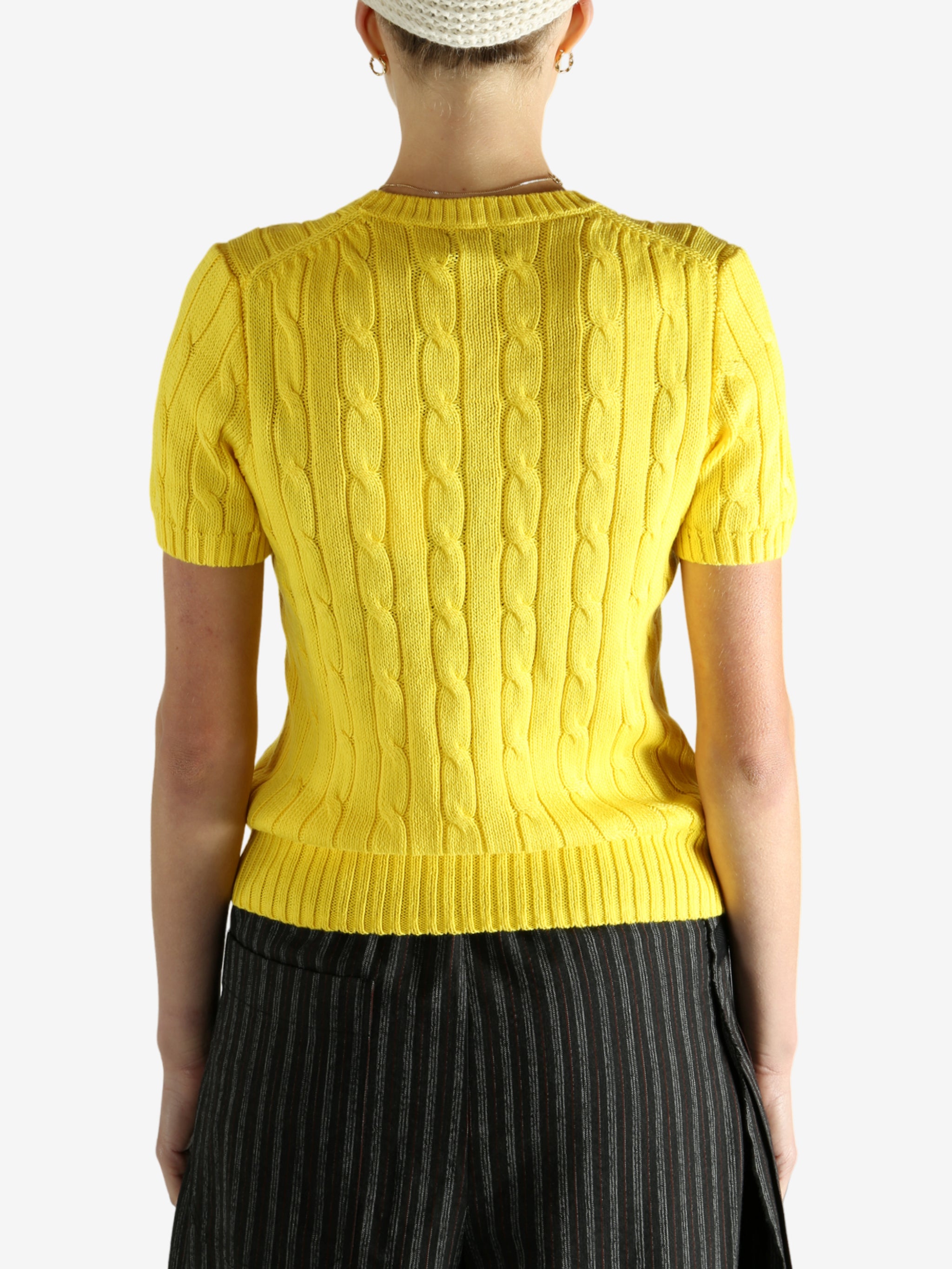 yellow sweater worn by a person, showing the sweater fit