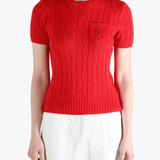 Red knitwear worn by a person, showing knitwear's fit