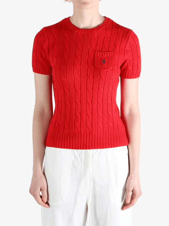 Red knitwear worn by a person, showing knitwear's fit