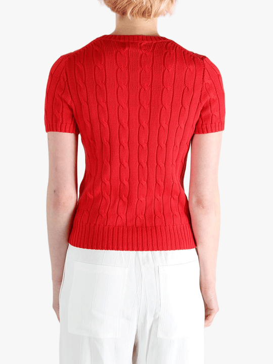 Red knitwear worn by a person, showing knitwear's fit