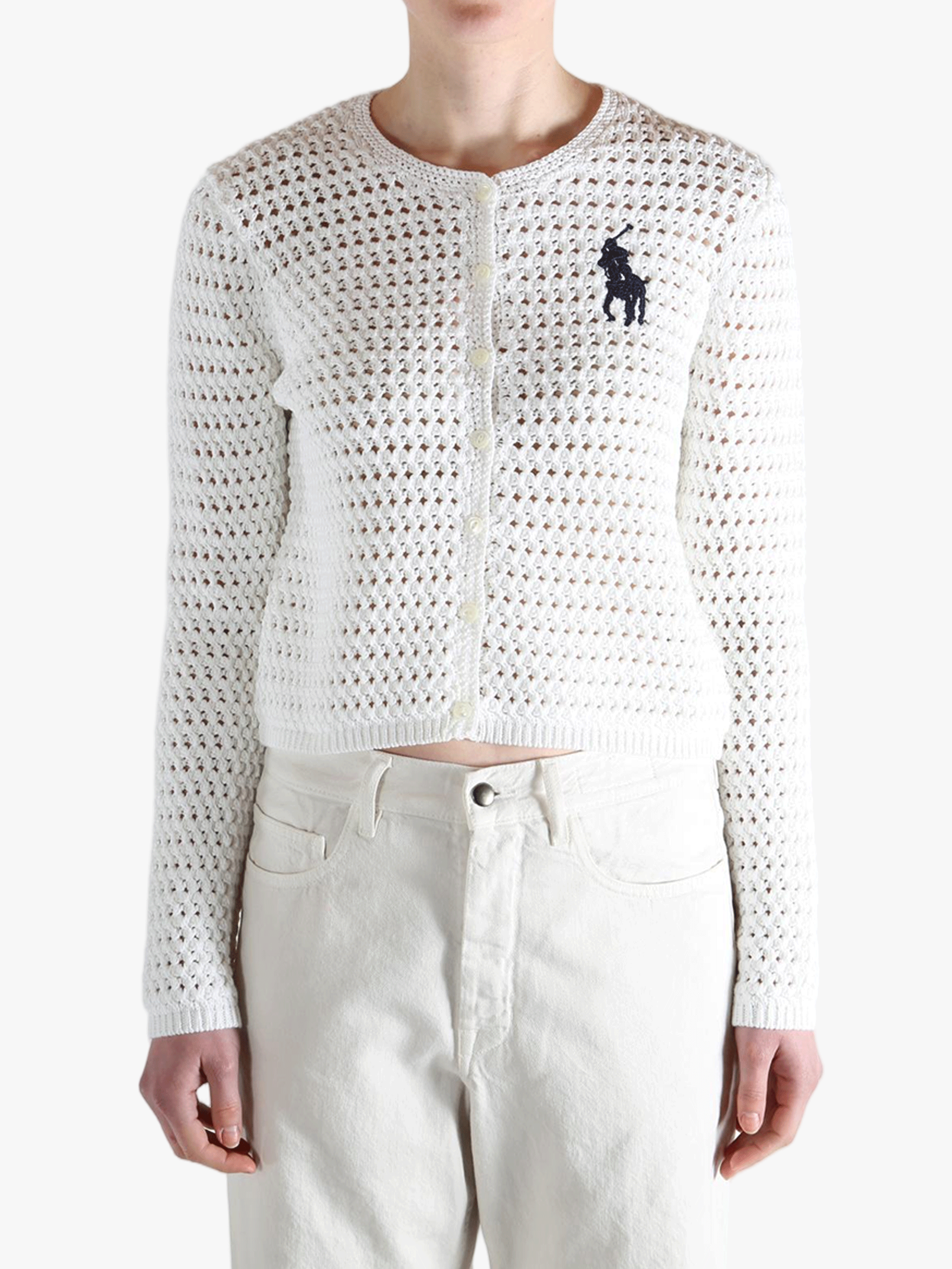 White sweater worn by a person, showing the sweater's fit