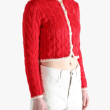 Red knitwear worn by a person, showing the knitwear fit