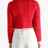 Red knitwear worn by a person, showing the knitwear fit
