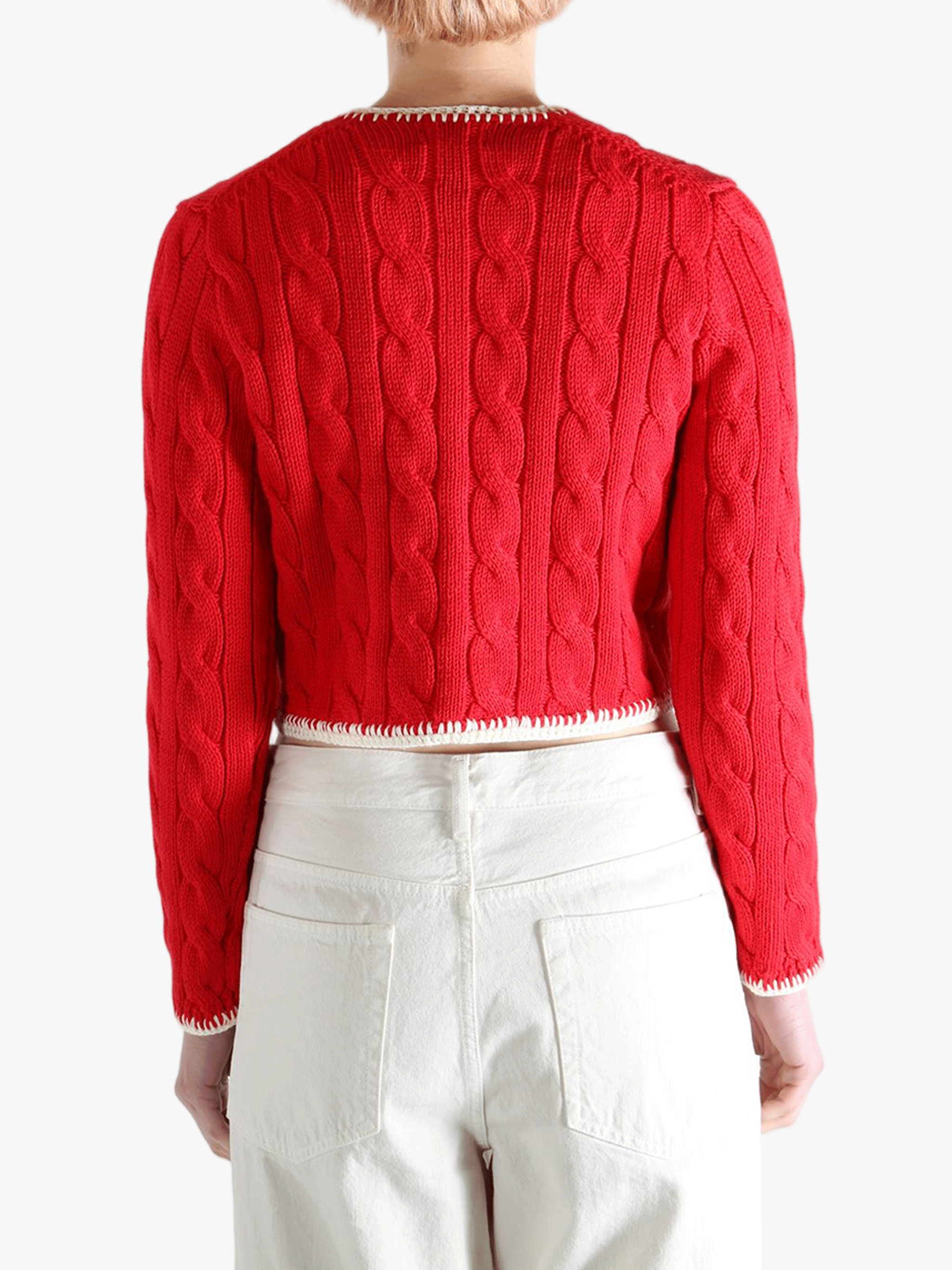 Red knitwear worn by a person, showing the knitwear fit