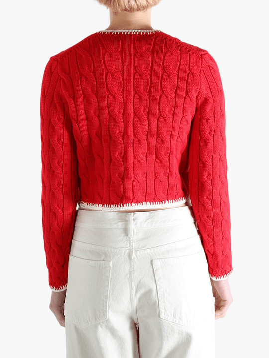 Red knitwear worn by a person, showing the knitwear fit