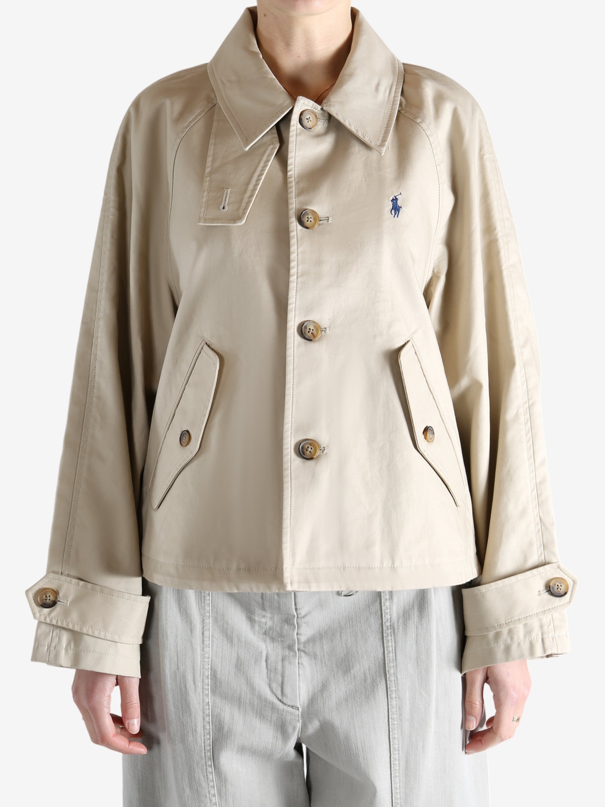 A tan jacket worn by a person, showing the jacket's fit