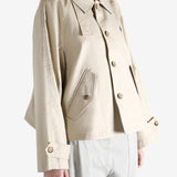 A tan jacket worn by a person, showing the jacket's fit
