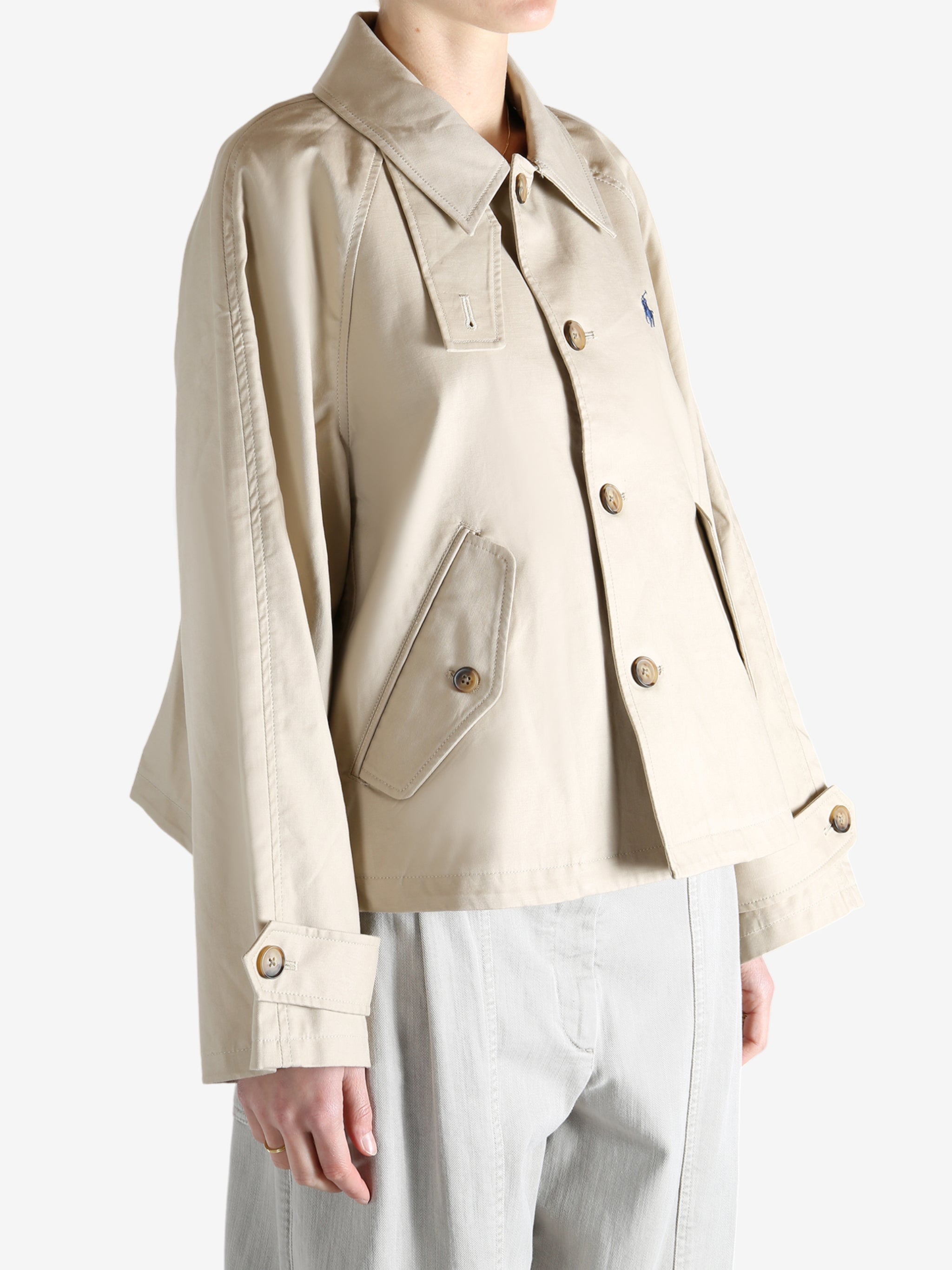 A tan jacket worn by a person, showing the jacket's fit