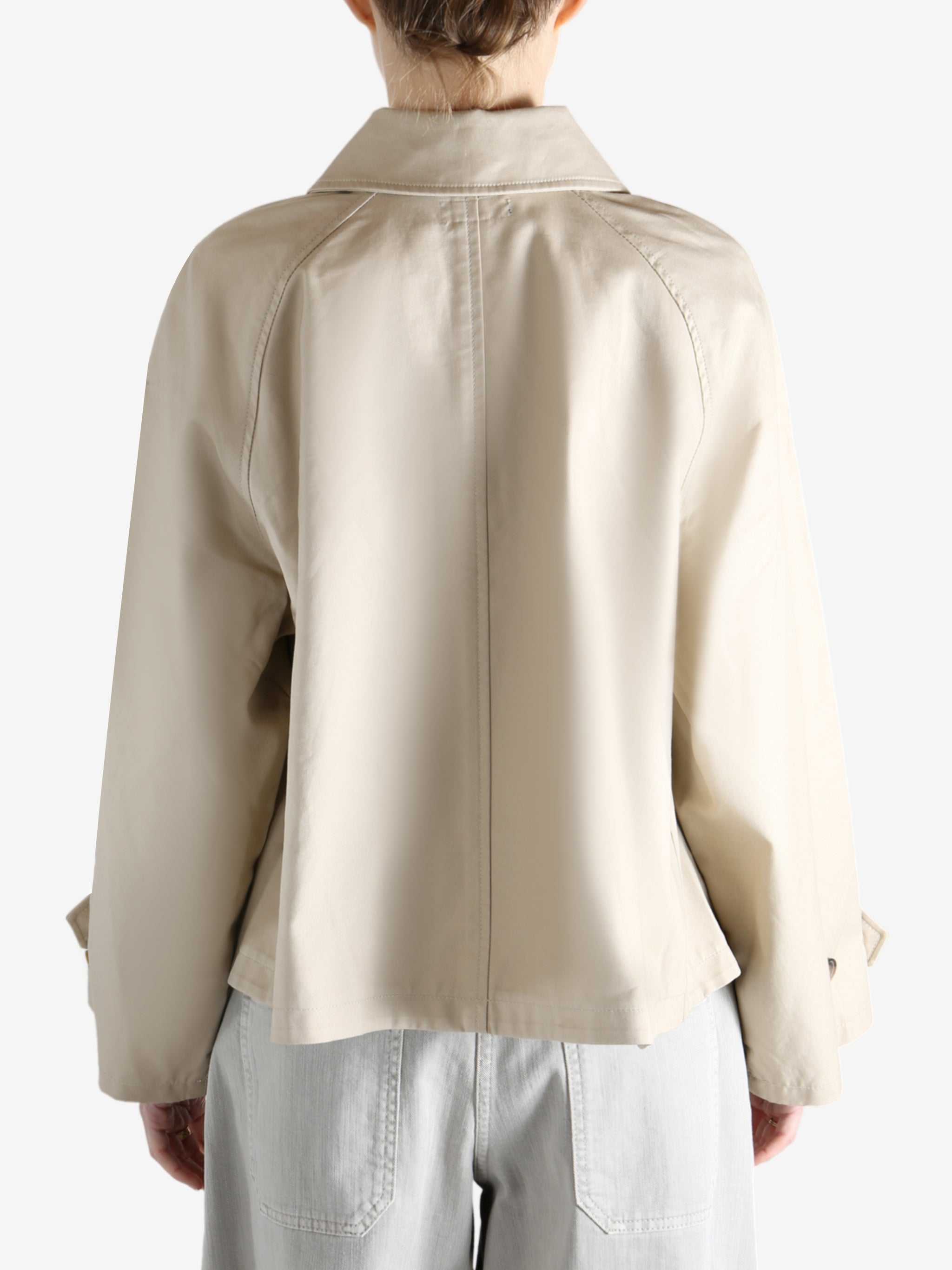 A tan jacket worn by a person, showing the jacket's fit