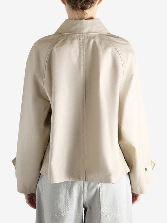 A tan jacket worn by a person, showing the jacket's fit