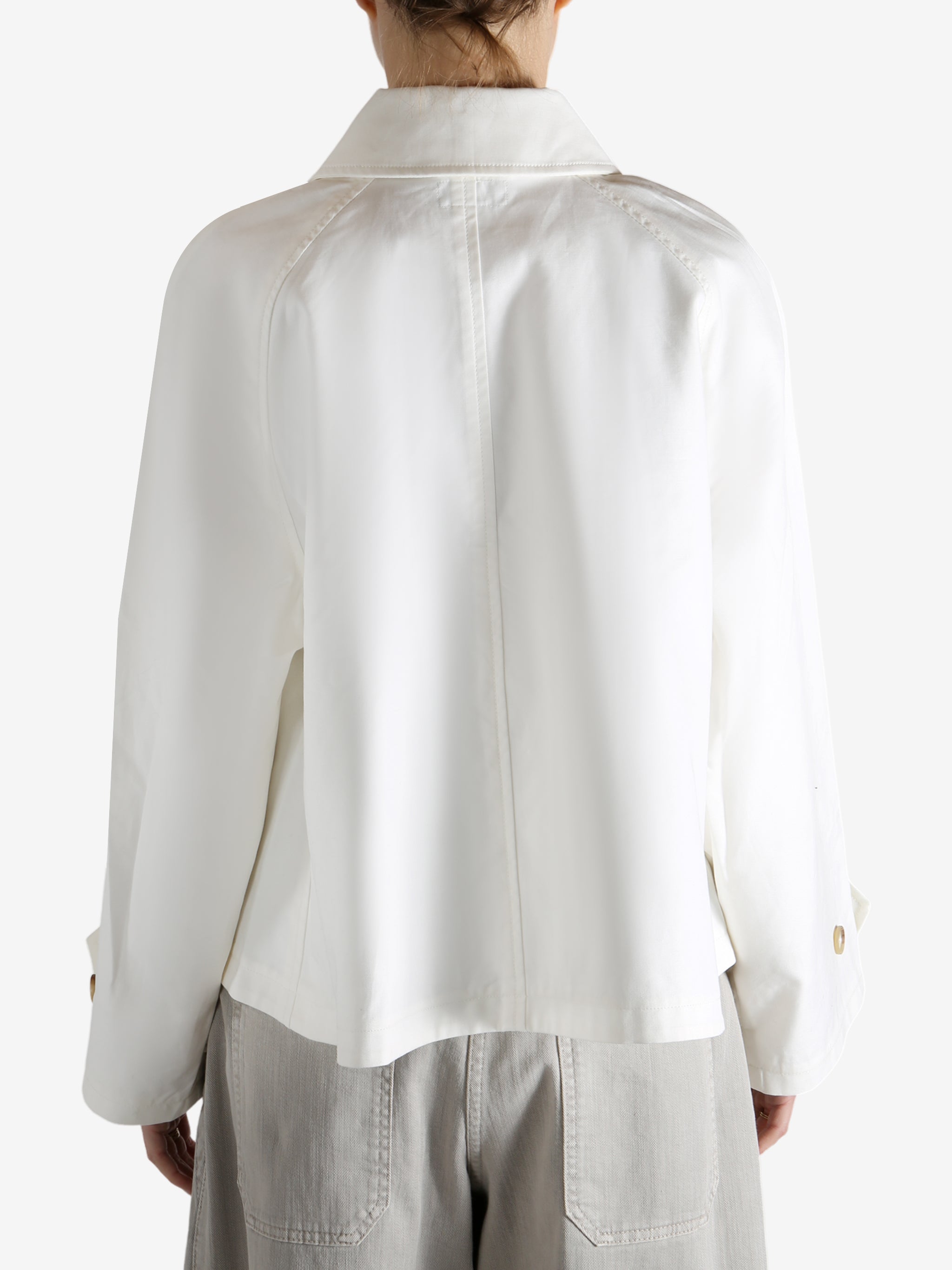 White jacket worn by a person, showing the jacket's fit
