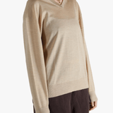 Tan sweater worn by a person, showing the sweater fit